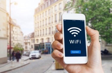 Public WiFi hotspot connection, city street, access internet on smartphone Public WiFi hotspot connection, city street, access internet on smartphone