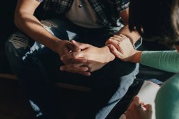People support each other in a rehab session disabled man in wheelchair in front of stairs