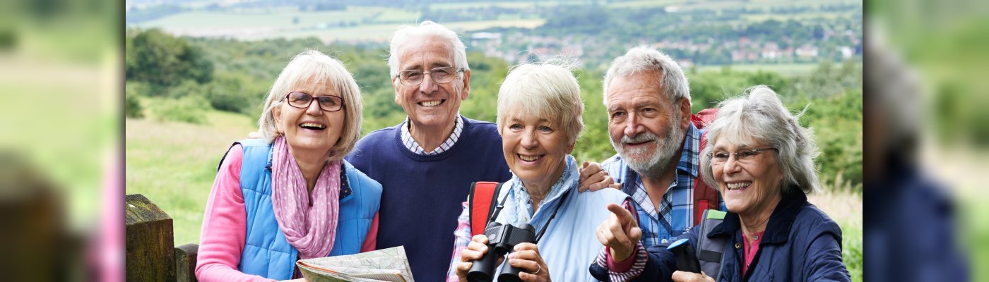 Group Of Senior Friends Hiking In Countryside