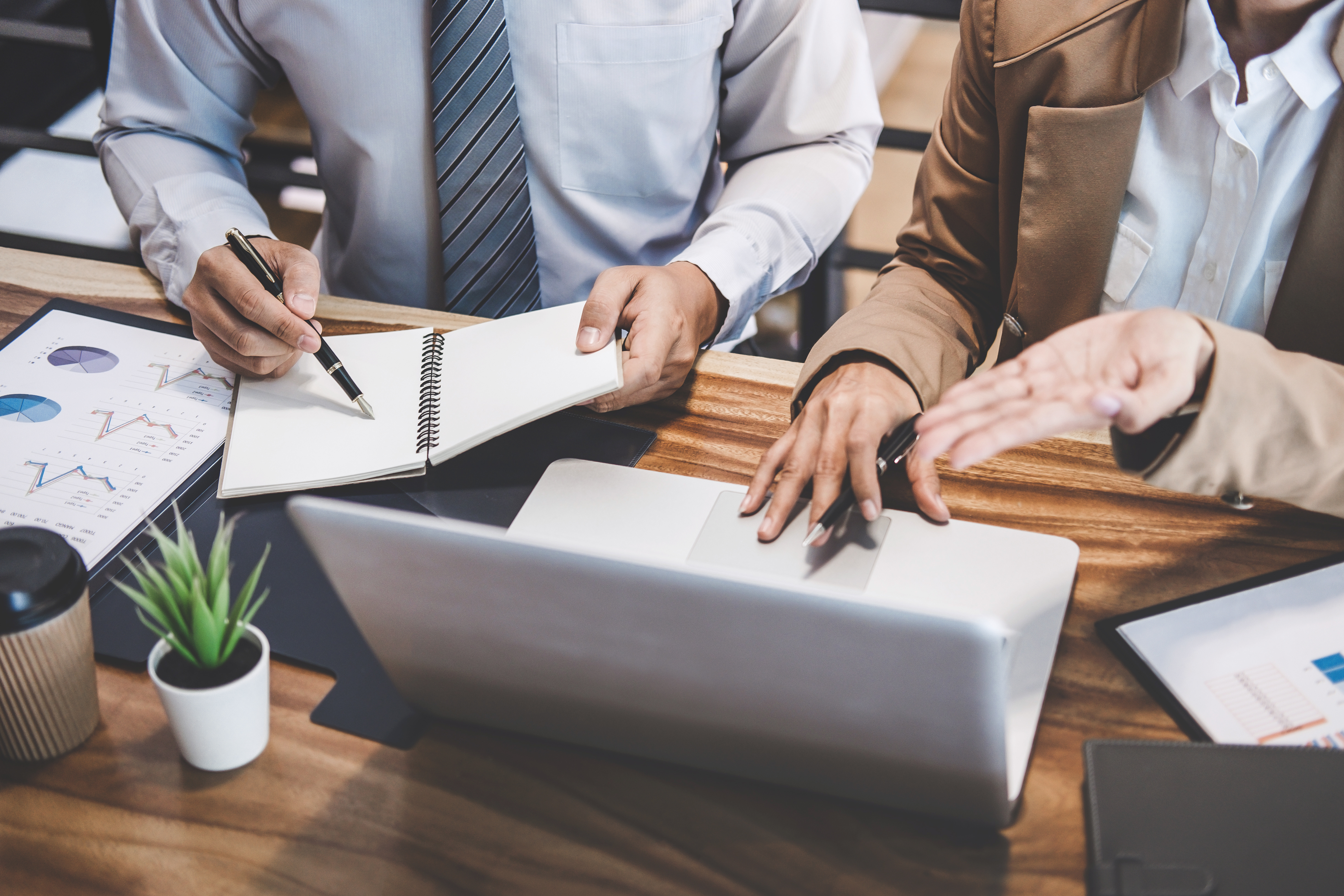 Geschäftsleute im Gespräch vor Laptop