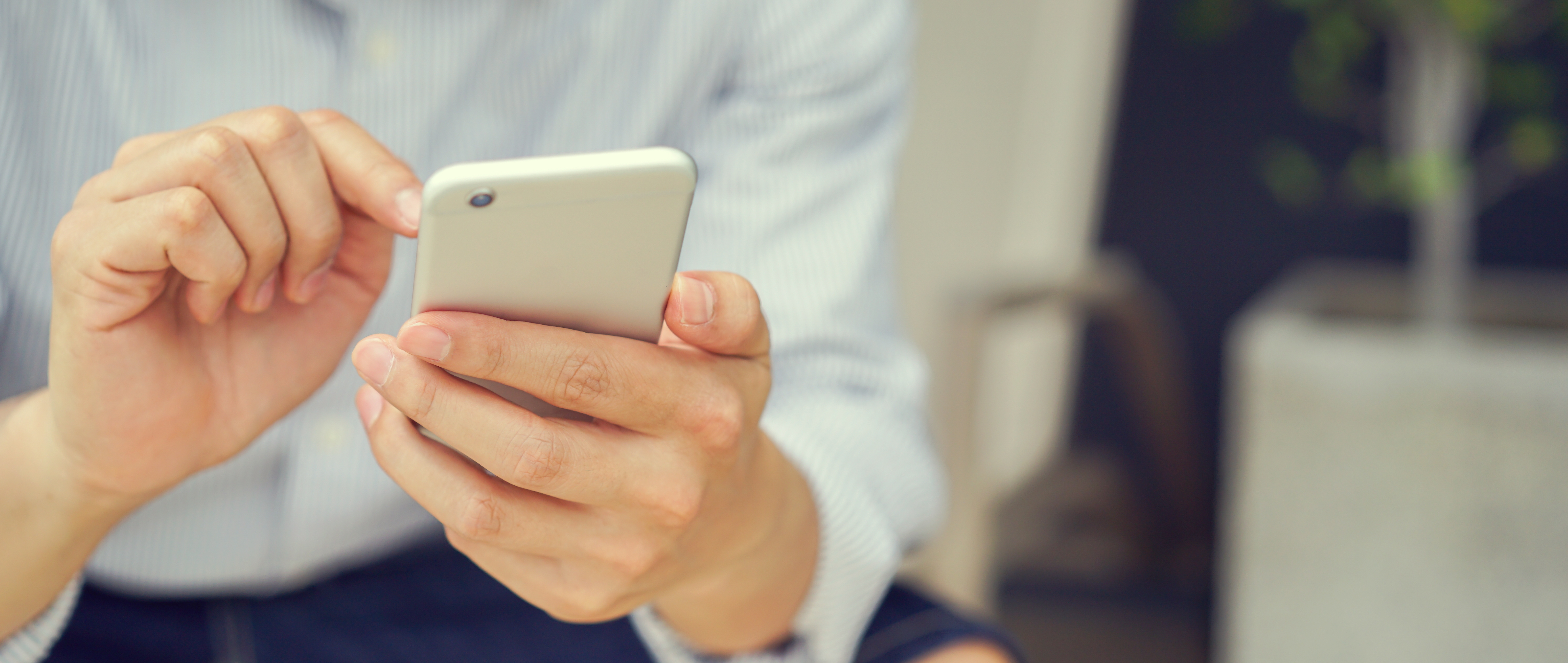 close up hand hold mobile cell phone device:focus on man play on smartphone concept