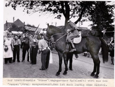 Kerbeburschen fahren mit einem Wagen durch die Stadt